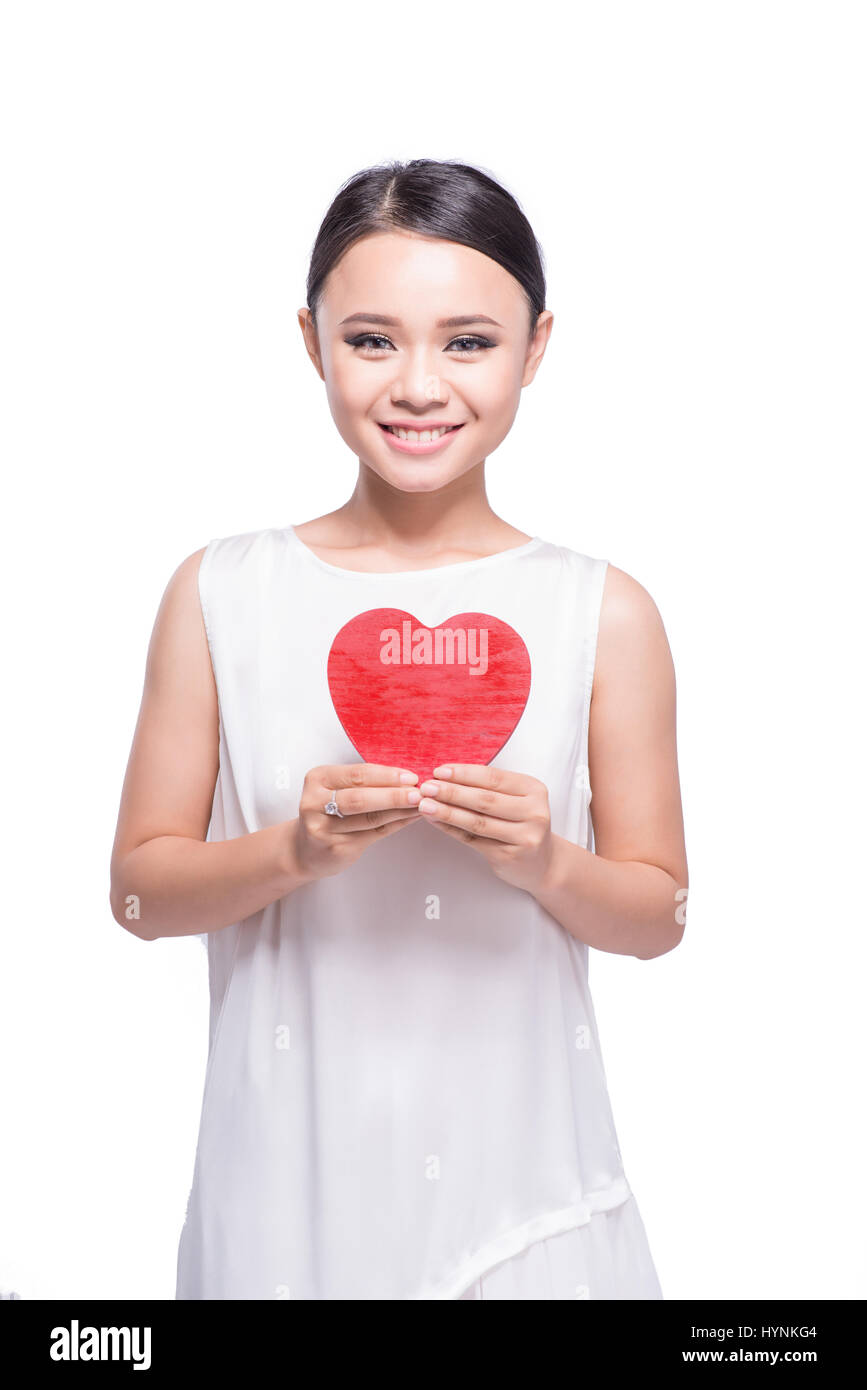 Beautiful young asian woman holding red heart on white Stock Photo - Alamy
