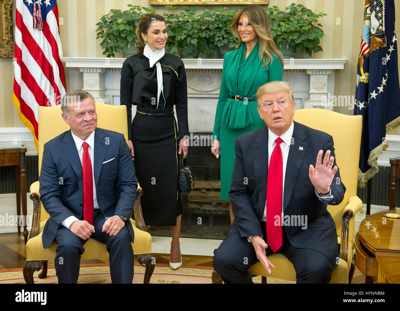 Washington, USA. 5th Apr, 2017. Washington DC, USA. 5th April, 2017. United States President Donald J. Trump asks for the press to stay as he makes a statement on Syria as he meets King Abdullah II of Jordan in the Oval Office of the White House in Washington, DC on Wednesday, April 5, 2017. Standing behind the President and King are Queen Rania of Jordan, left, and first lady Melania Trump, right. Credit: MediaPunch Inc/Alamy Live News Stock Photo