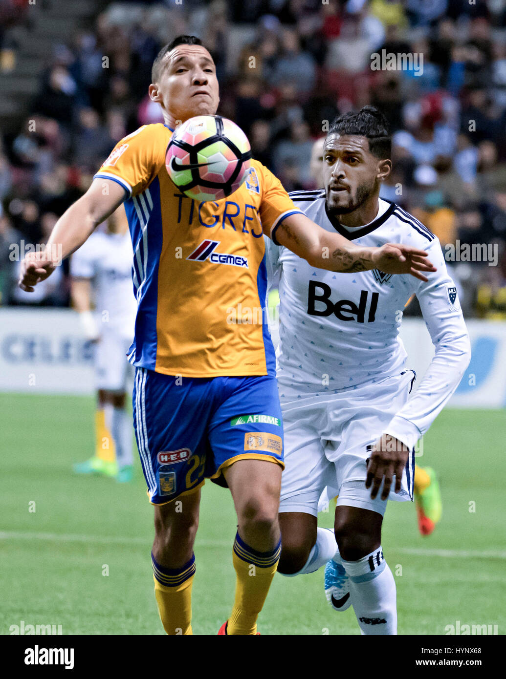 (170406) -- VANCOUVER, April, 6, 2017 (Xinhua) -- Jesus Duenas Manzo(L) of Mexico's Tigres UANL vies with Sheanon Williams of Major League Soccer's Canadian Vancouver Whitecaps during the second-leg match of the CONCACAF Champions League 2016/2017 Semifinal in Vancouver, Canada, April 5, 2017. Tigres UANL won 2-1 and advanced to the final with 4-1 on aggregate. (Xinhua/Andrew Soong) Stock Photo