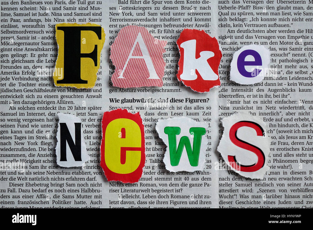 ILLUSTRATION - 'FAke News' is spelled out in colourful letters on top of a news article. Taken 29.12.2016. 'Fake News' refers to false and incorrect information, often spread on purpose via electronic channels (mainly social media). They are deliberately spread by journalists, office-holders, politicians, companies and private individuals. In the German language, the word 'fake' has no exact cognate, and the English word is increasingly used by internet users and as a result has developed an association with internet culture and online jargon. These days fake news stories (untrue information p Stock Photo