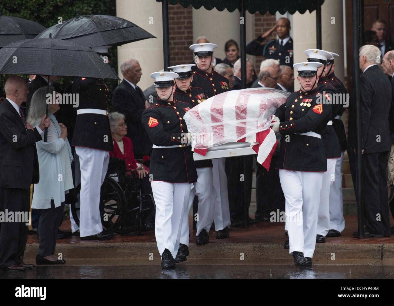 Arlington, Virginia, USA. 6th Apr, 2017. Marines with Marine Barracks Washington load the remains of John Glenn onto a horse drawn hearse outside the Old Post Chapel, Ft. Meyer April 6, 2017 in Arlington, Virginia. Glenn, the first American astronaut to orbit the Earth and later a United States senator, died at the age of 95 on December 8, 2016. Credit: Planetpix/Alamy Live News Stock Photo