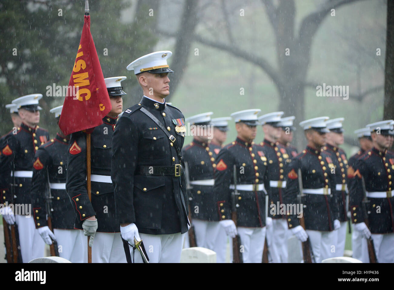 Arlington, Virginia, USA. 6th Apr, 2017. Marine Corps honor guard stand at attention during the gravesite funeral services for John Glenn at Arlington National Cemetery April 6, 2017 in Arlington, Virginia. Glenn, the first American astronaut to orbit the Earth and later a United States senator, died at the age of 95 on December 8, 2016. Credit: Planetpix/Alamy Live News Stock Photo