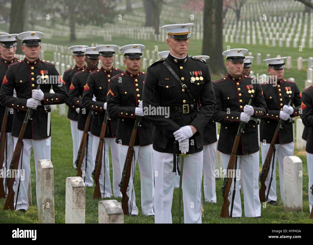 Arlington, Virginia, USA. 6th Apr, 2017. Marine Corps honor guard stand at ease during the gravesite funeral services for John Glenn at Arlington National Cemetery April 6, 2017 in Arlington, Virginia. Glenn, the first American astronaut to orbit the Earth and later a United States senator, died at the age of 95 on December 8, 2016. Credit: Planetpix/Alamy Live News Stock Photo