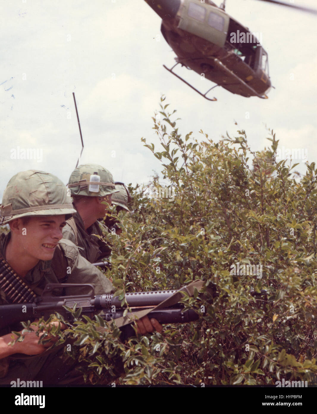 During a mission conducted by a U.S. Army infantry platoon west of Duc Pho, troops prepare to move out in search of a suspected Viet Cong outpost as a Huey takes off, Vietnam, April 24, 1967. Stock Photo