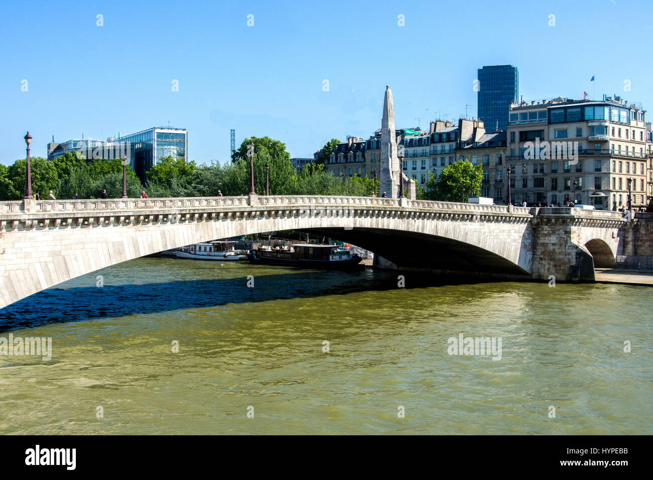 France, Paris 6eme, Pont de la Tournelle bridge above the Seine River with statue of St Genevieve and the famous restaurant La Tour d'Argent on the banks Stock Photo
