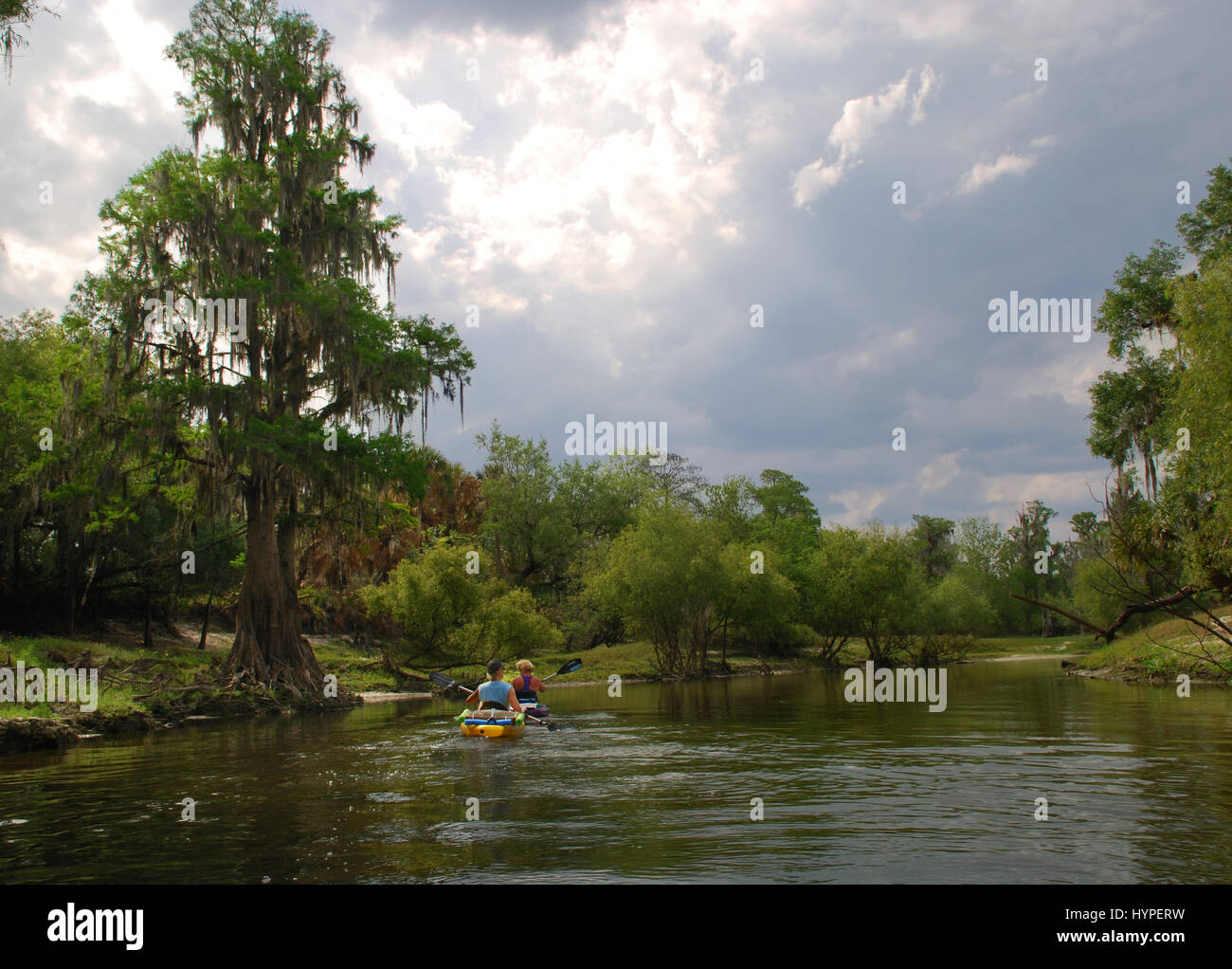 Two kayakers paddle The Peace River in Arcadia, Florida, USA Stock Photo