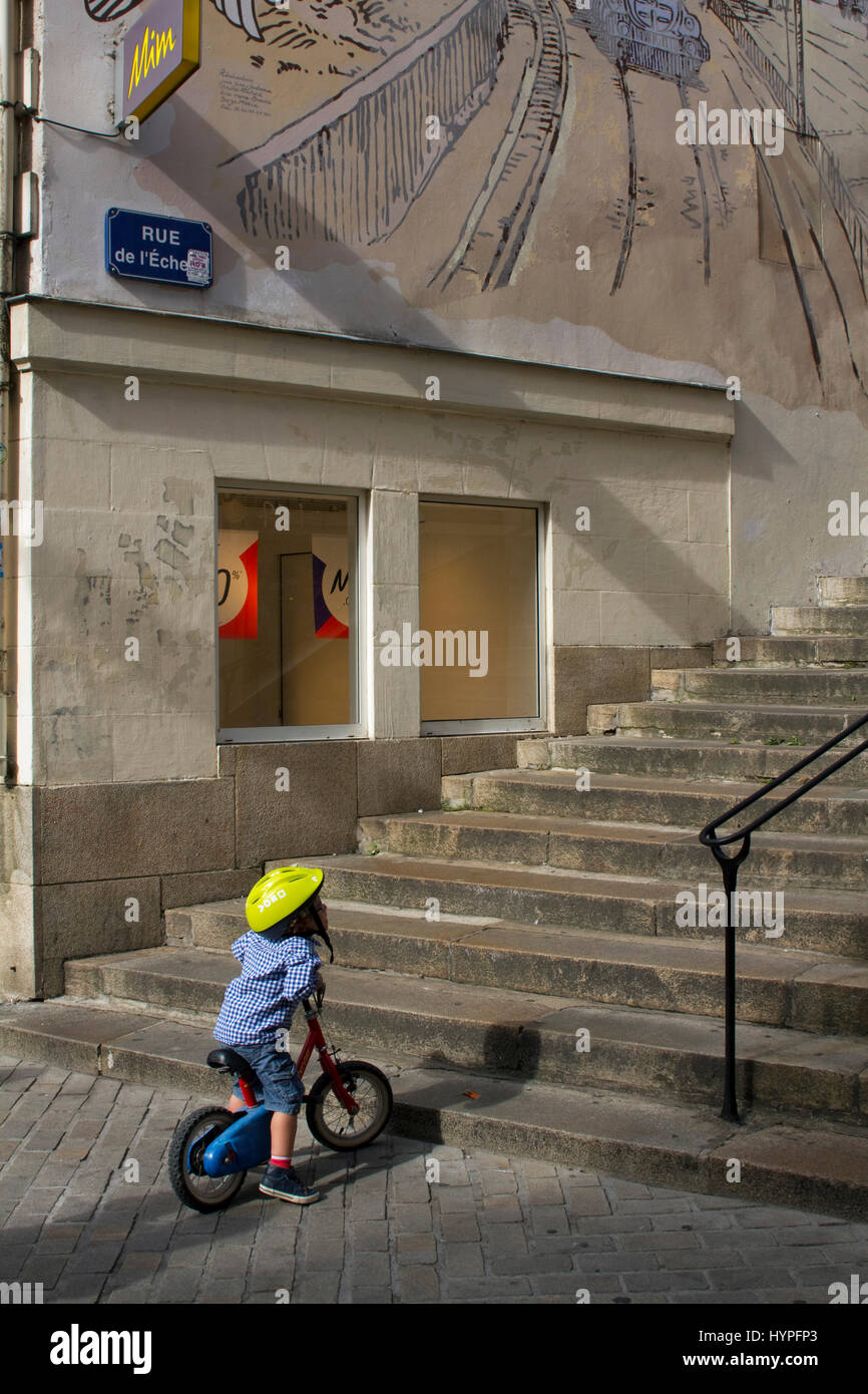 France, North Western France, Nantes, small child on his bicycle at the bottom of  staircases. Stock Photo