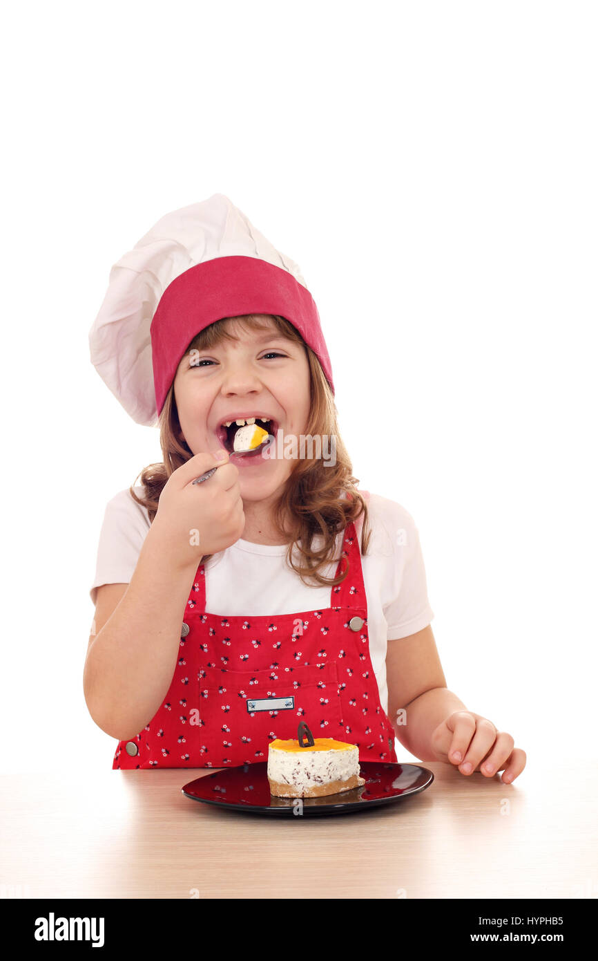 hungry little cook girl eat cake Stock Photo