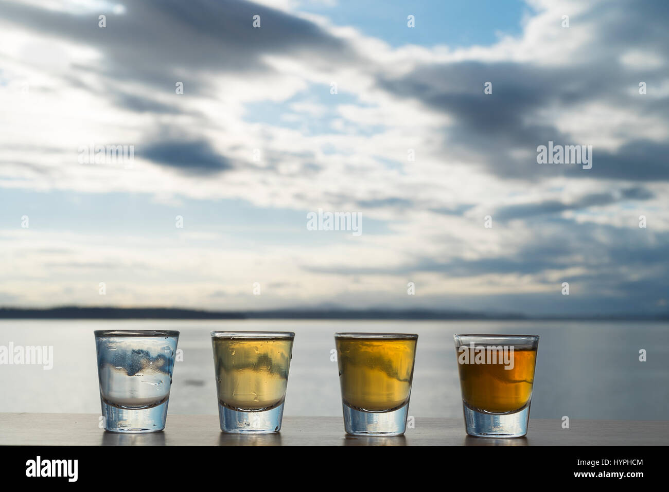 Alcohol shots of four types tequila on seaside beach table Stock Photo Alamy