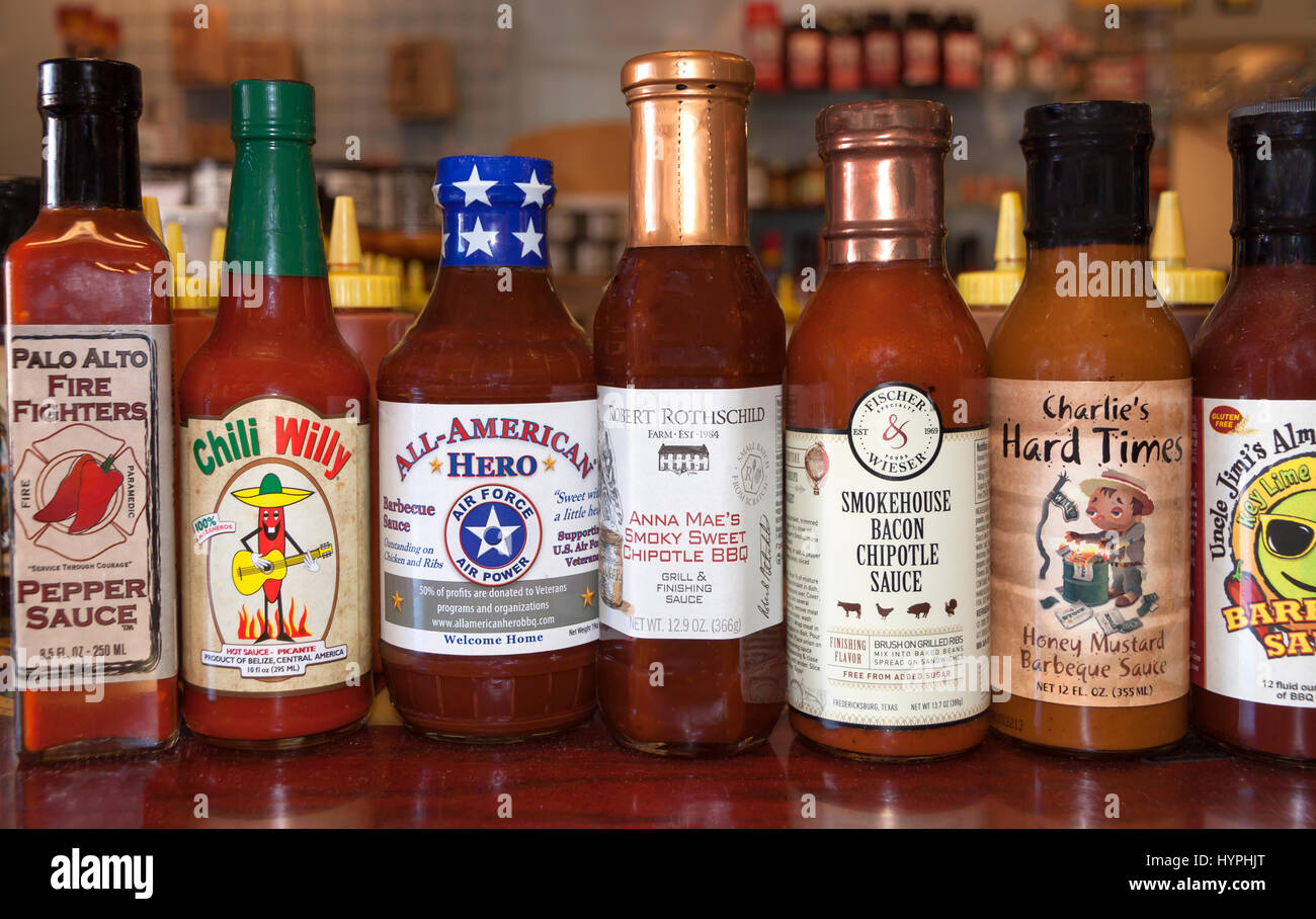 Hot sauces on display in a store hires stock photography and images