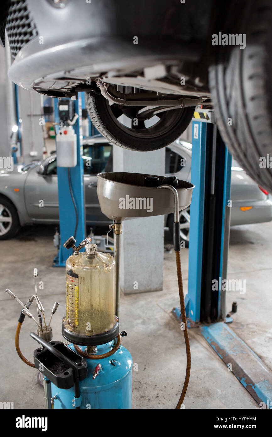 Old used oil filters. Equipment for oil changing in car repair station