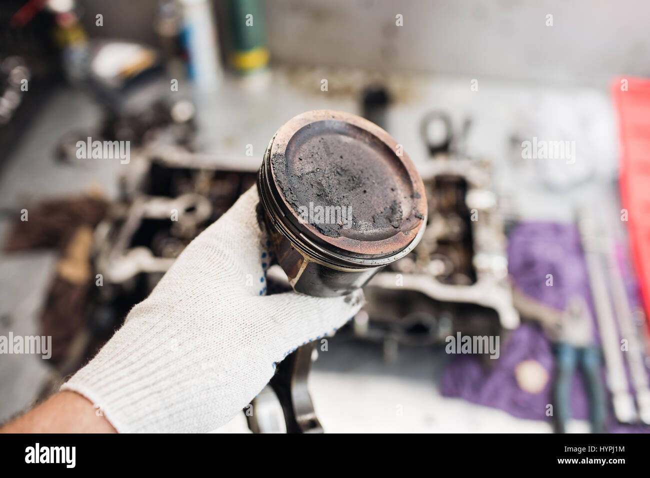 Car mechanic in garage with old car engine piston Stock Photo Alamy