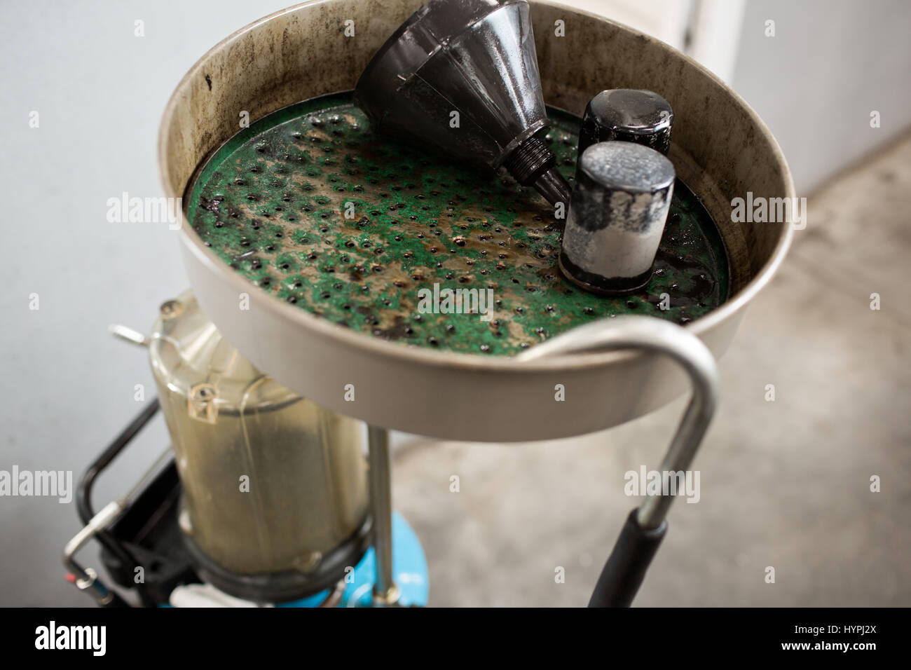 Old used oil filters. Equipment for oil changing in car repair station