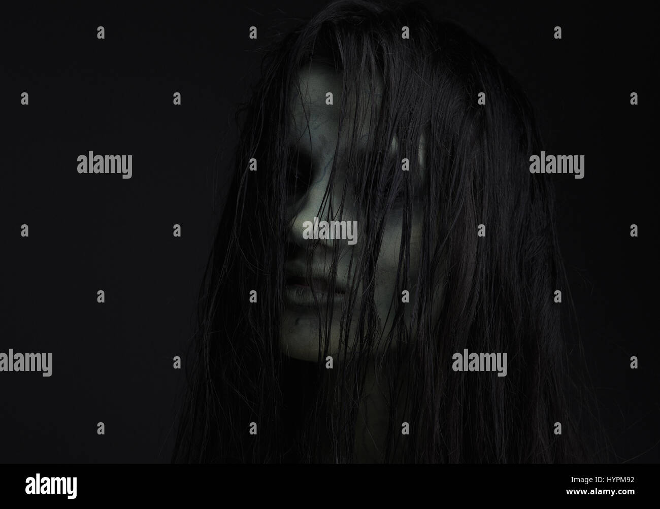 Close up portrait of a horror girl. Spooky conceptual portrait of a zombie woman Stock Photo