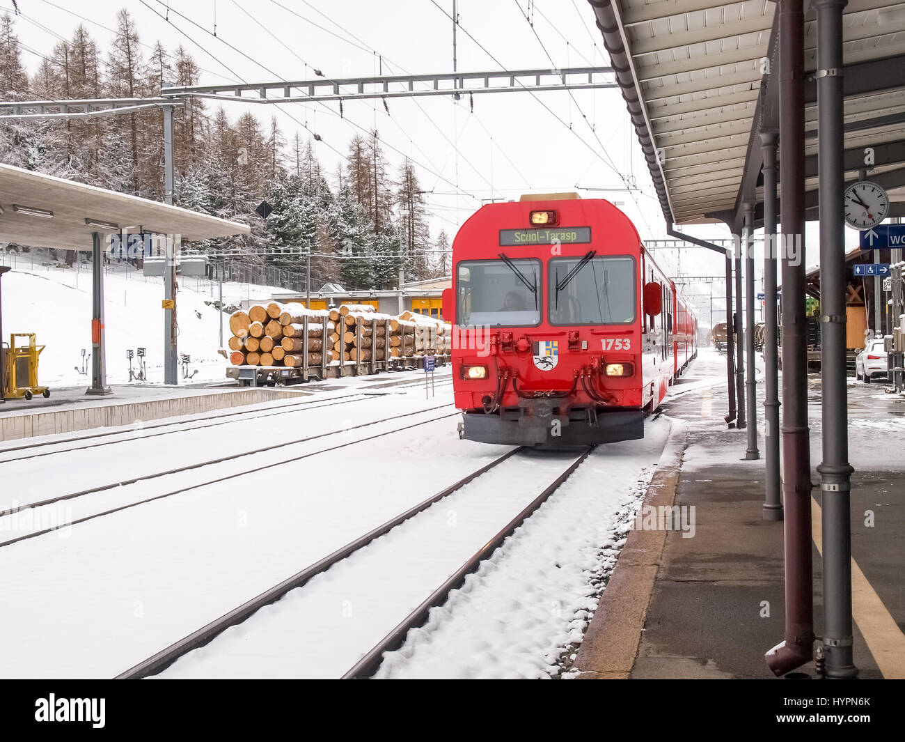 Poschiavo, Switzerland - April 27, 2016: Train of the Rhaetian Railway in transit at the Poschiavo station during a snowy day. Stock Photo