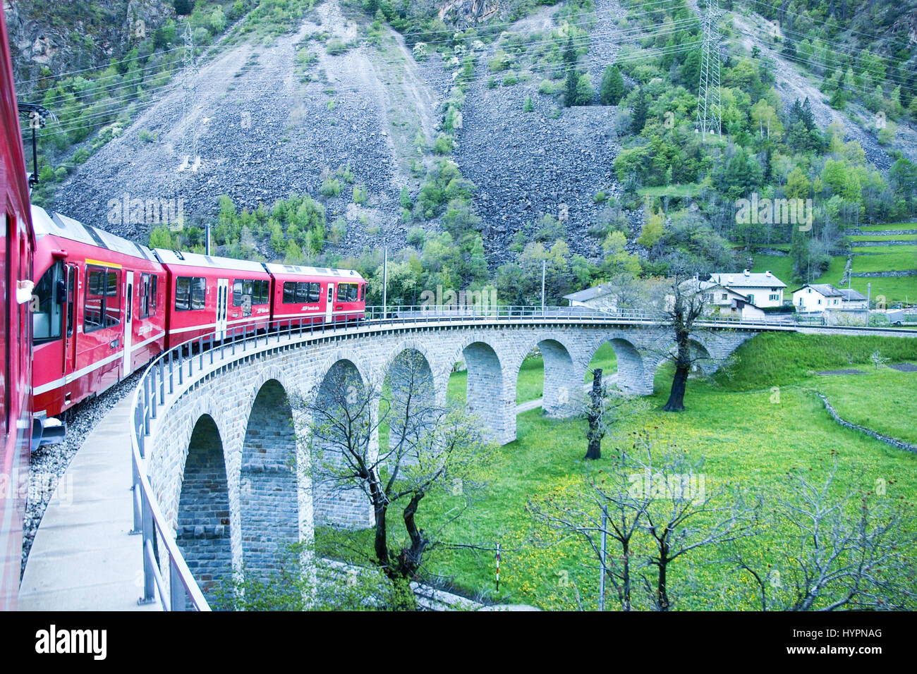 Brusio, Switzerland - April 27, 2016: trains of the Rhaetian Railway in transit along the line from Tirano to St.Moritz. Stock Photo