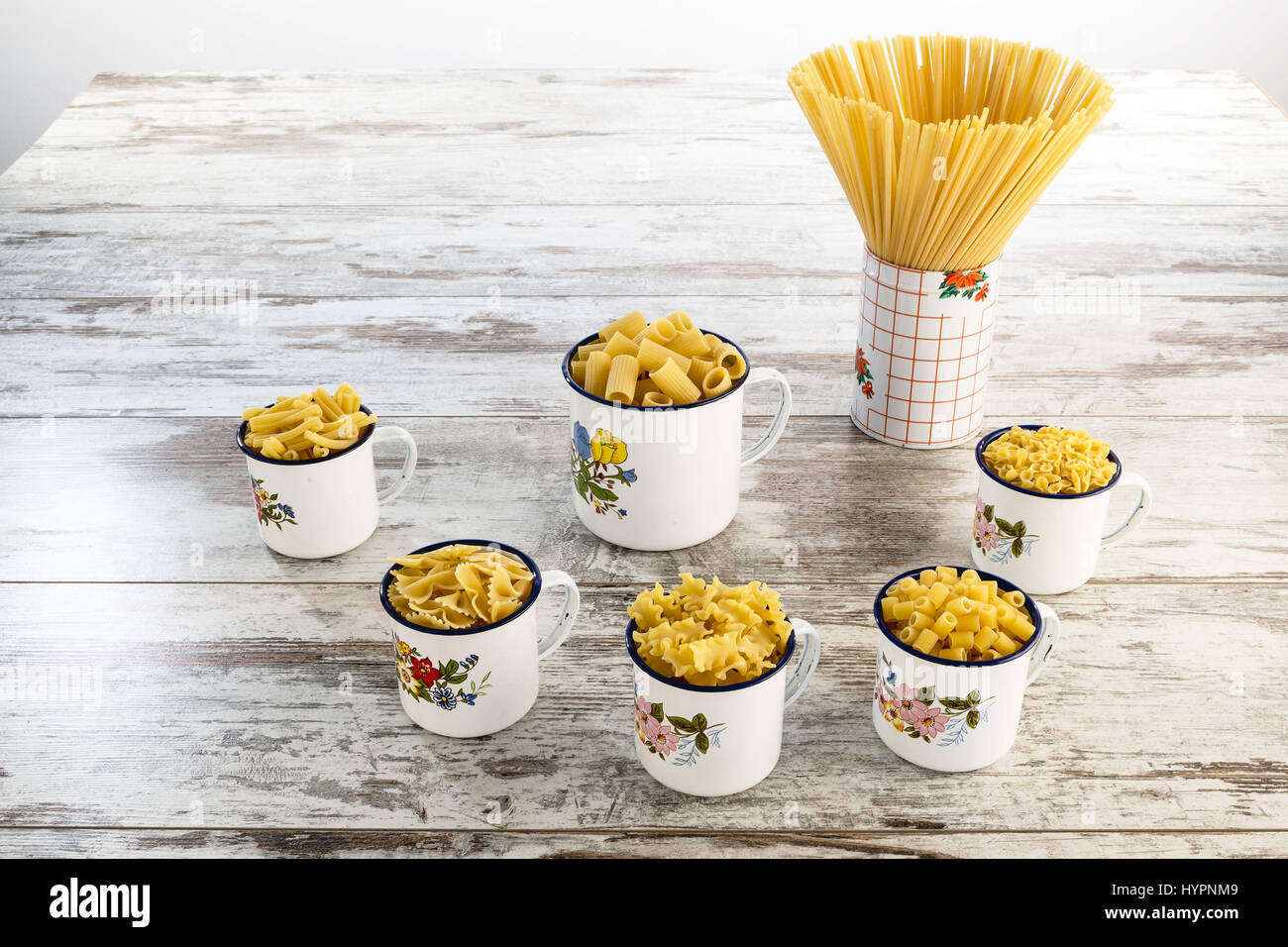 short and long dried pasta in metal cups from above Stock Photo