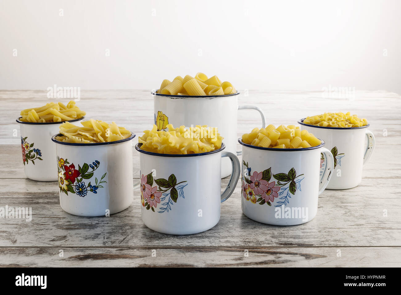 bottom short dry pasta in metal cups from the bottom Stock Photo