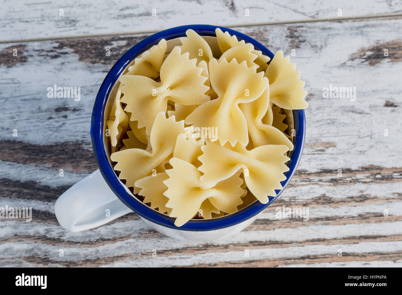 dried pasta in metal bowl butterflies Angle Stock Photo