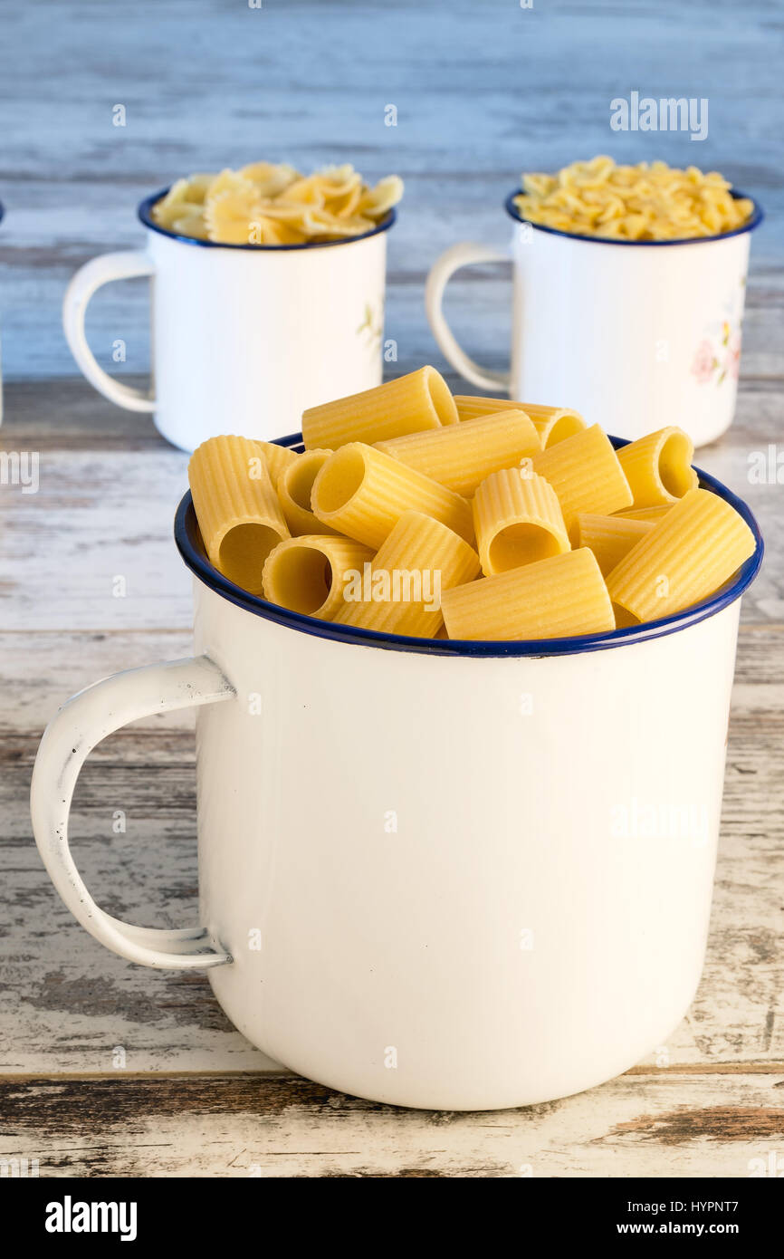 short dry pasta in metallic bowl short sleeves front Stock Photo