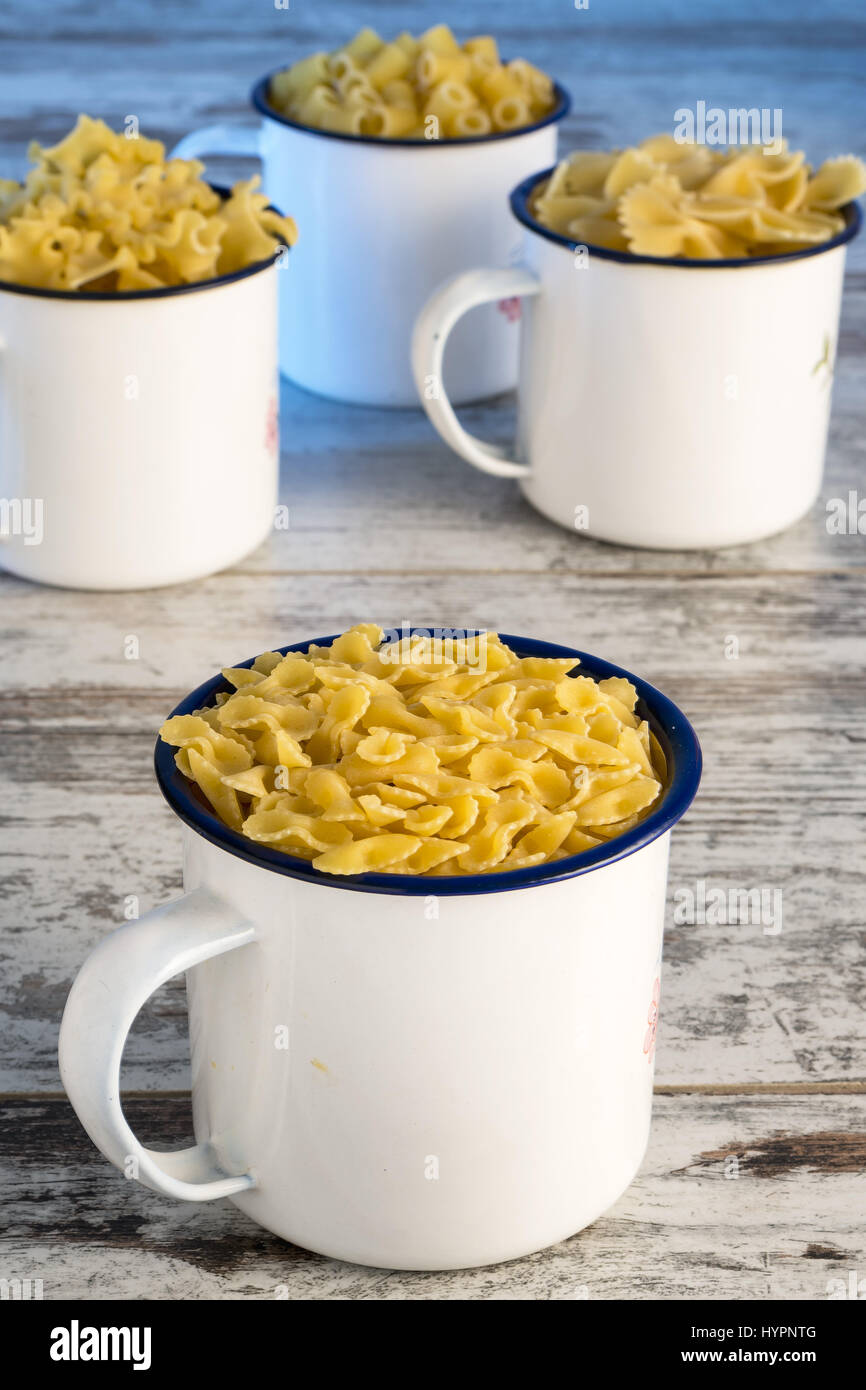 dried pasta in metal cup farfalline front Stock Photo