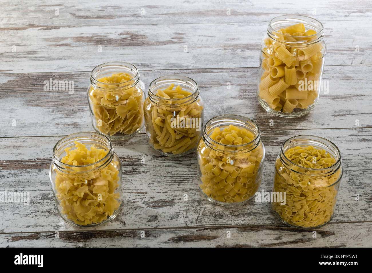 short dry pasta in glass jars from above Stock Photo