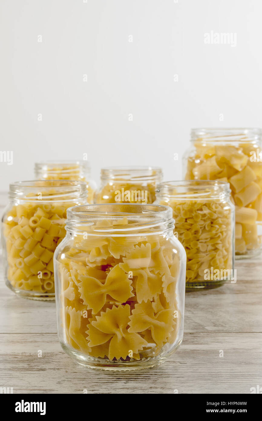 short dry pasta in glass jar butterflies front Stock Photo