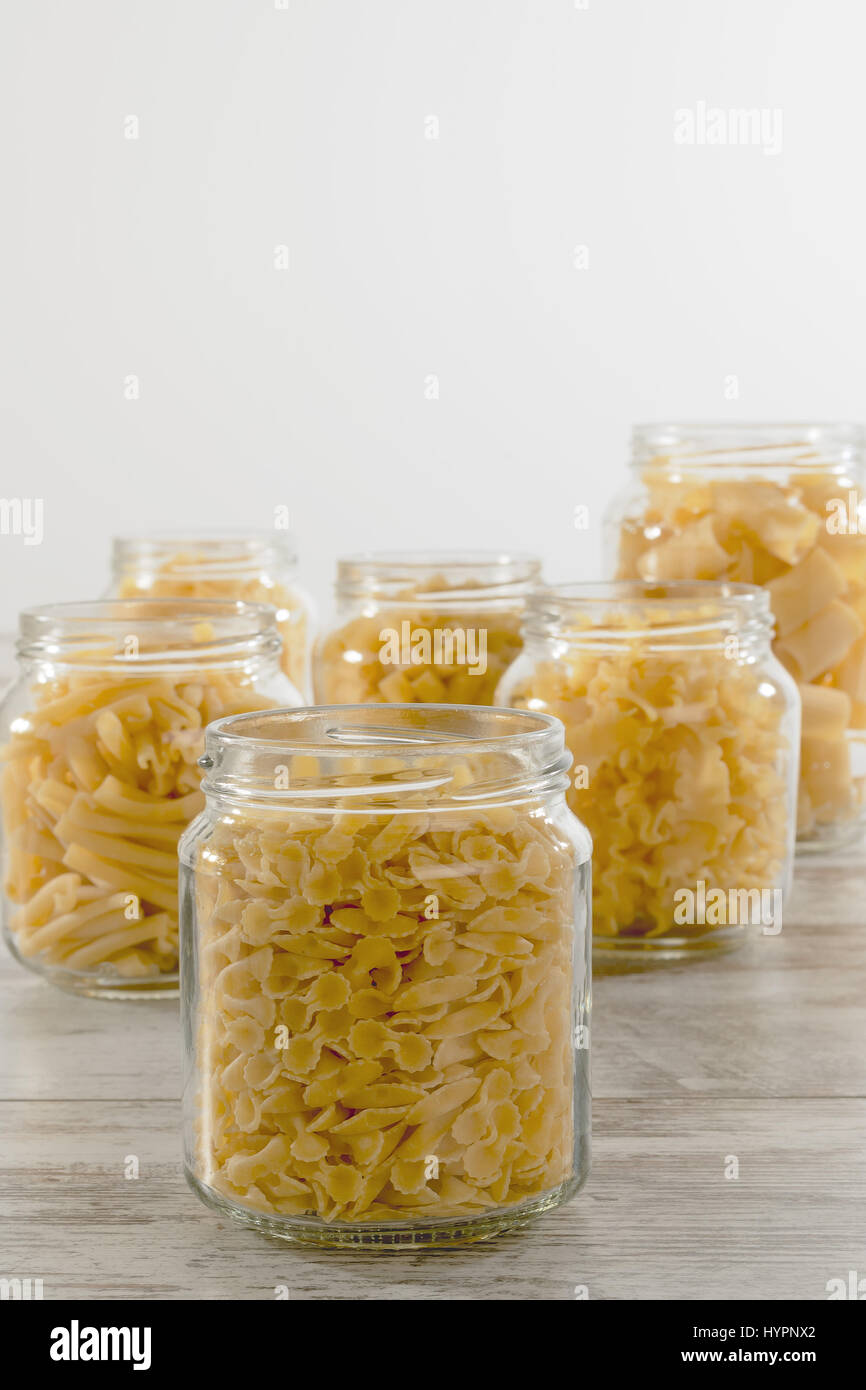 short dry pasta in glass jar farfalline front Stock Photo