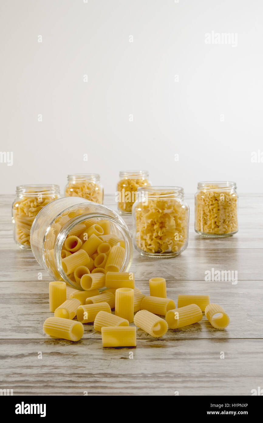 short dry pasta in glass jar upside down short sleeves ribbed front Stock Photo