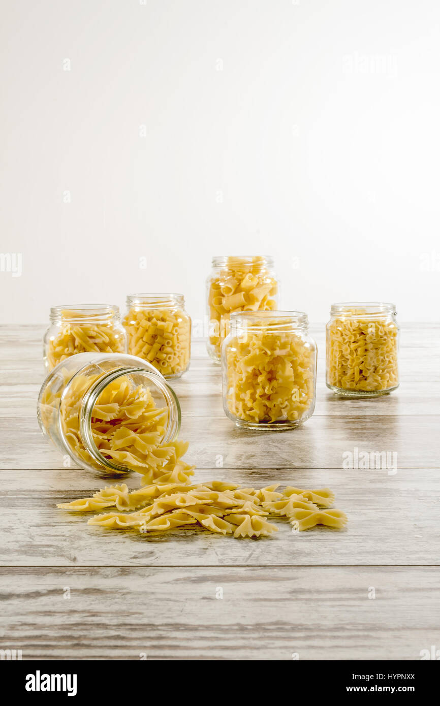 short dry pasta in glass jar inverted front butterflies Stock Photo