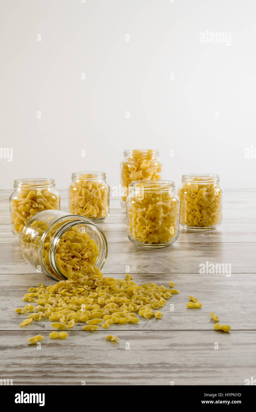 dried pasta in glass jar inverted front farfalline Stock Photo