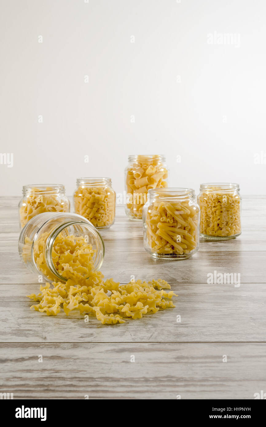short pasta in glass jar inverted front reginelle Stock Photo