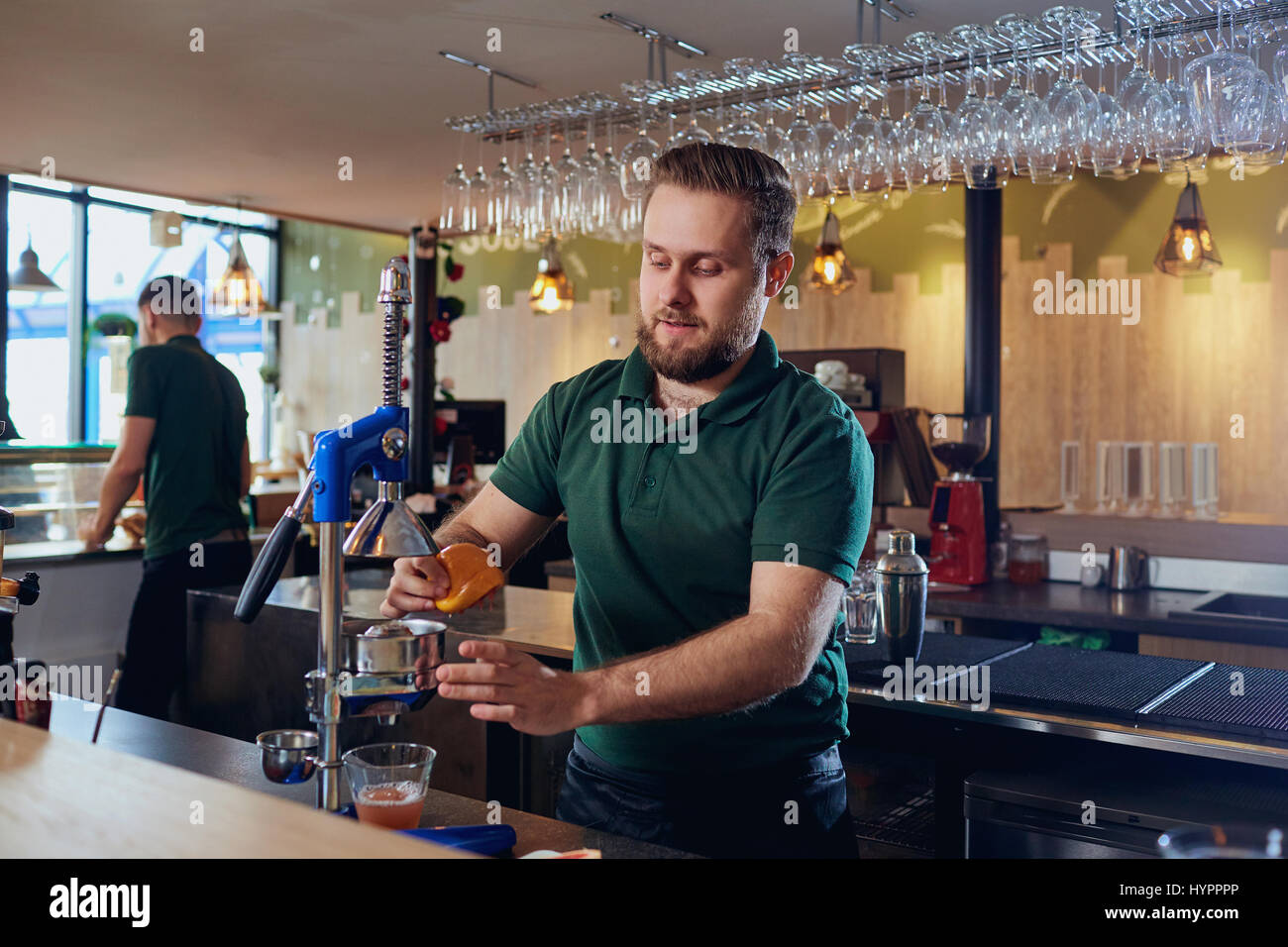 The barman prepares fresh juice at bar Stock Photo