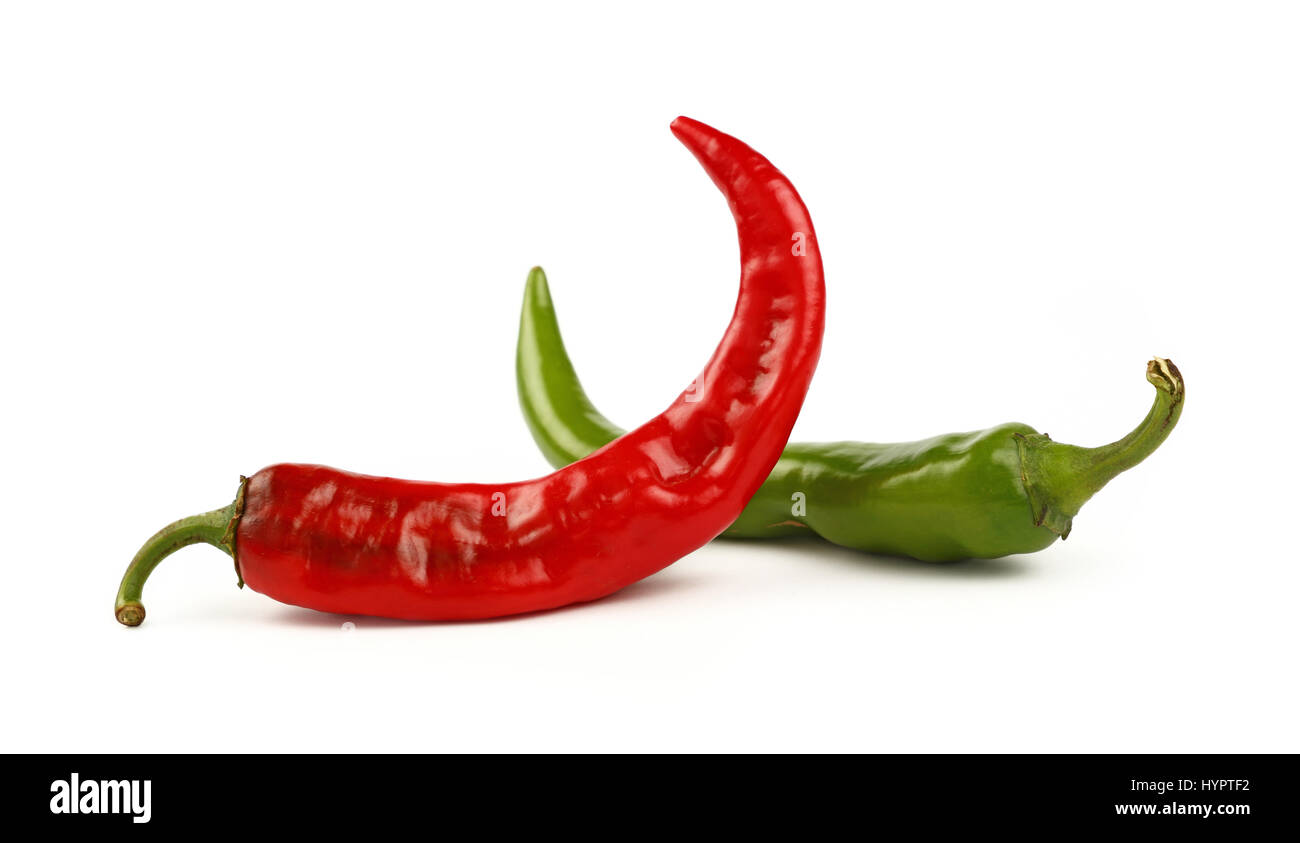 Two fresh green jalapeno and red hot chili peppers crossed isolated on