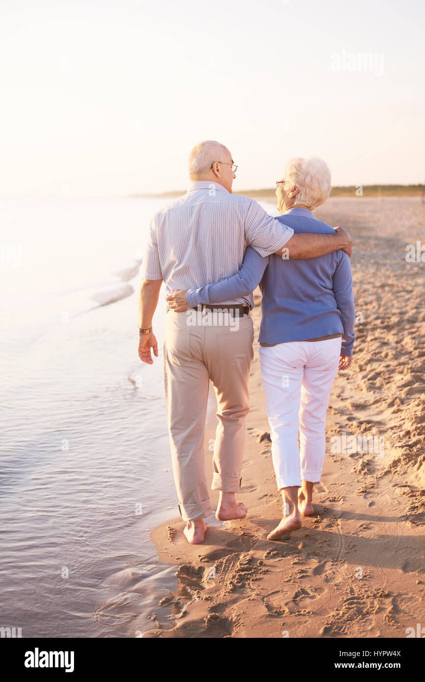 Two senior adults by the ocean Stock Photo