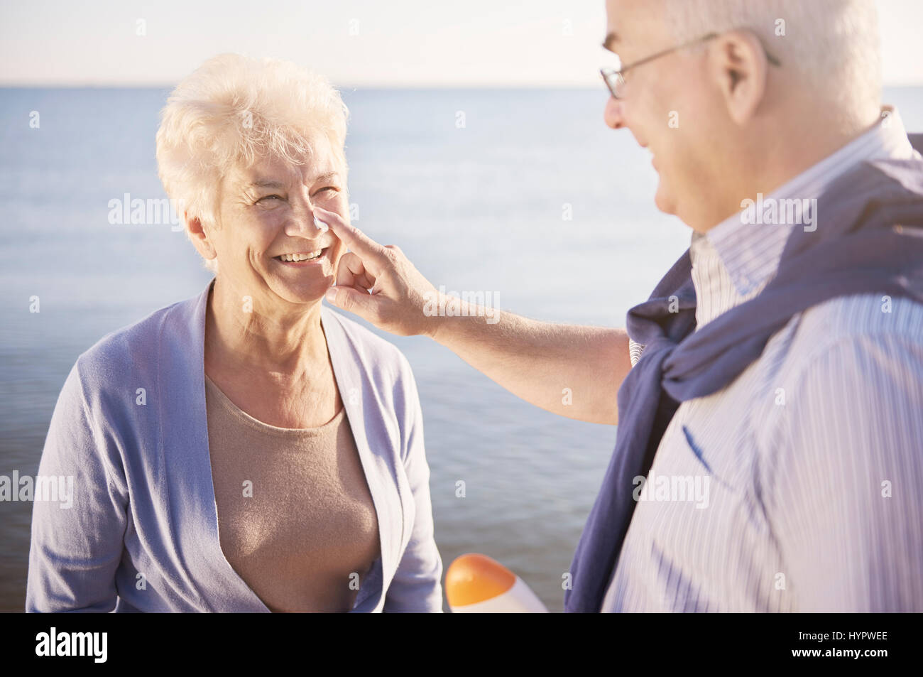 Man applying suntan lotion woman hires stock photography and images