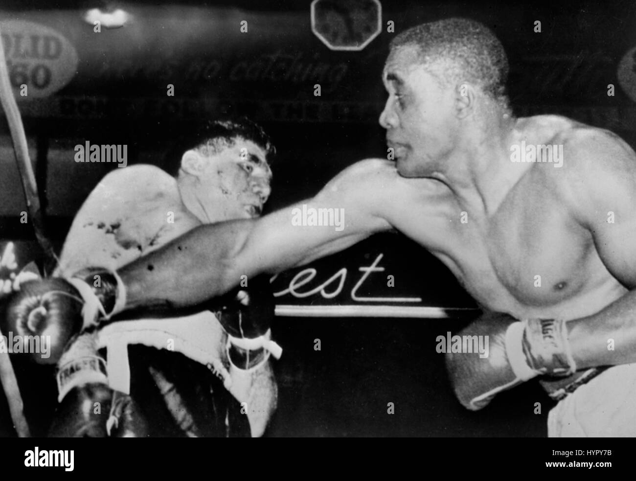 Willi Besmanoff (l), cornered by Sonny Liston, reels away from a hard right cross just before the end of the sixth round of their fight  at Cleveland.  Referee Mike Minnich stopped the fight at the end of the 6th round, giving 4th ranked Sonny Liston his 19th straight heavyweight victory. Stock Photo