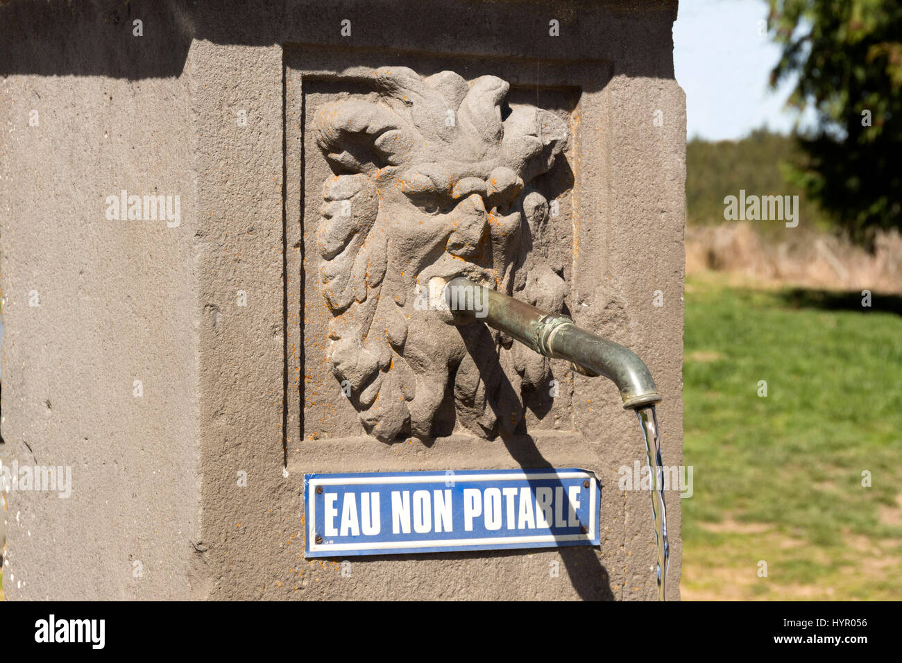 Tap at a village fountain with "Eau Non Potable" sign indicating the water is not drinkable. Auvergne. France Stock Photo