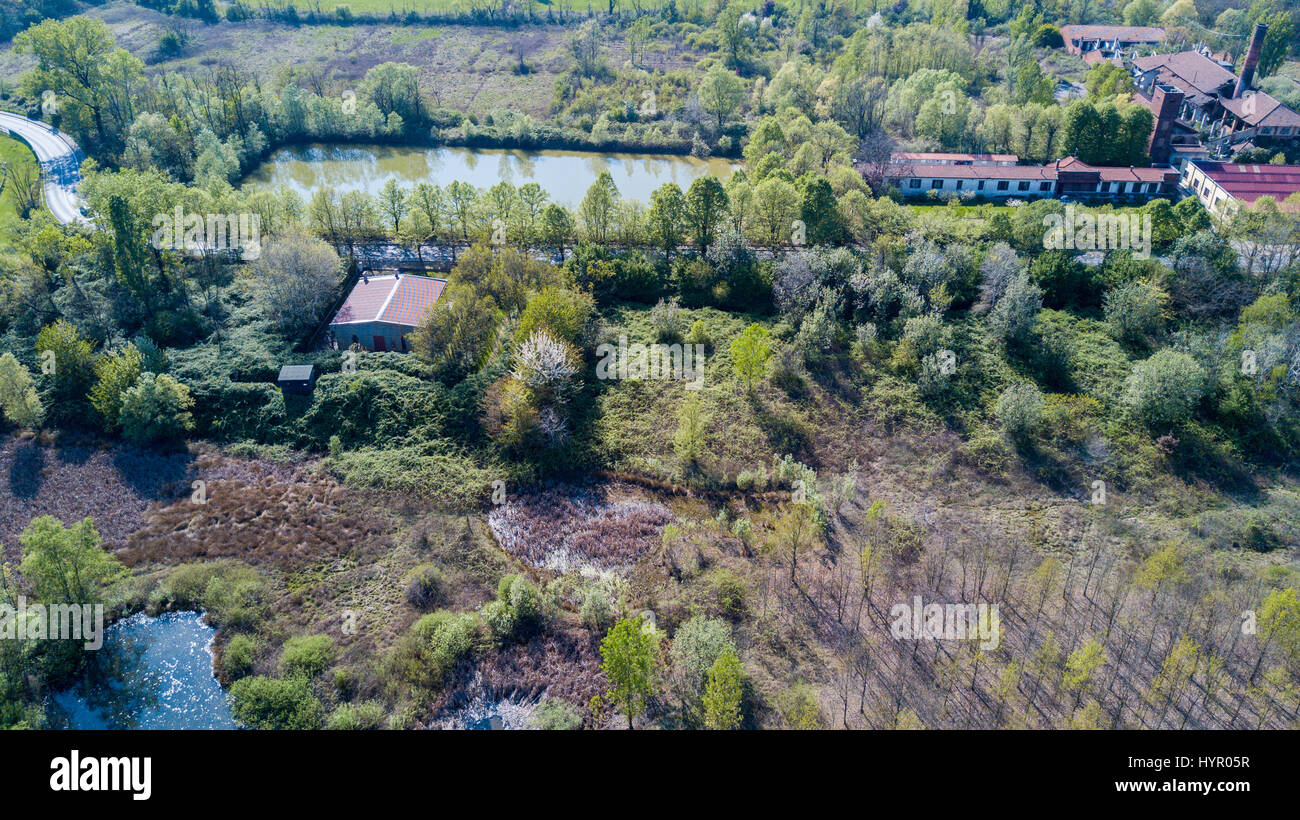 Nature and landscape: Aerial view of a furnace and chimney, woods and lakes, green and trees. Groane Park, Mombello, Limbiate, Milan, Italy Stock Photo