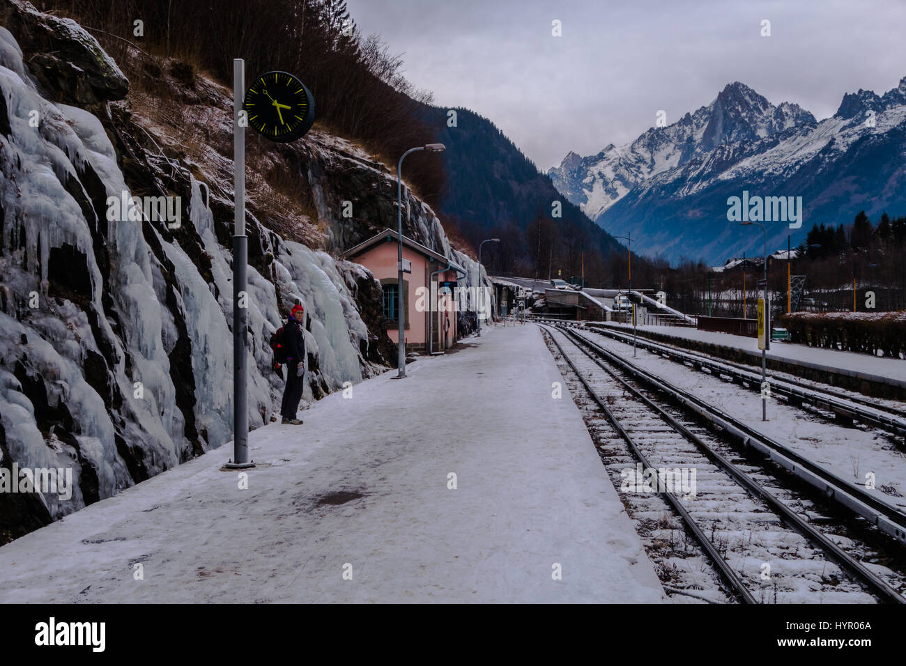 Chamonix, France - January 2, 2017: Traveller waiting in cold weather on overcast day in mountain valley in Alps in winter Stock Photo
