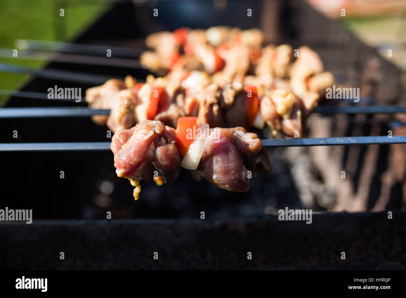 Grilling marinated shashlik on a grill. Shashlik is a form of Shish kebab  popular in Eastern, Central Europe and other places. Shashlyk meaning skewer  Stock Photo - Alamy