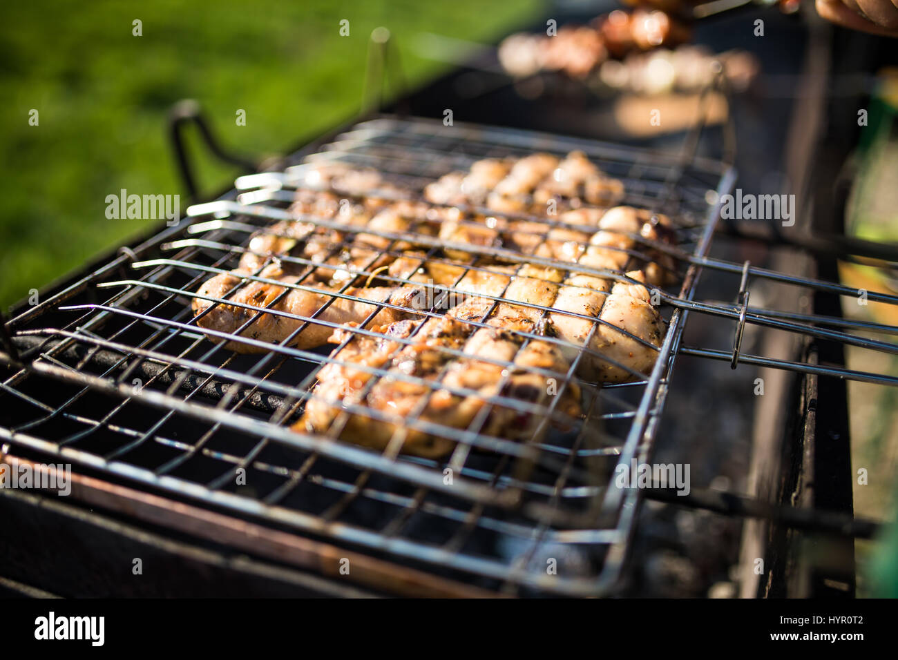 Grilling marinated shashlik on a grill. Shashlik is a form of Shish kebab  popular in Eastern, Central Europe and other places. Shashlyk meaning skewer  Stock Photo - Alamy