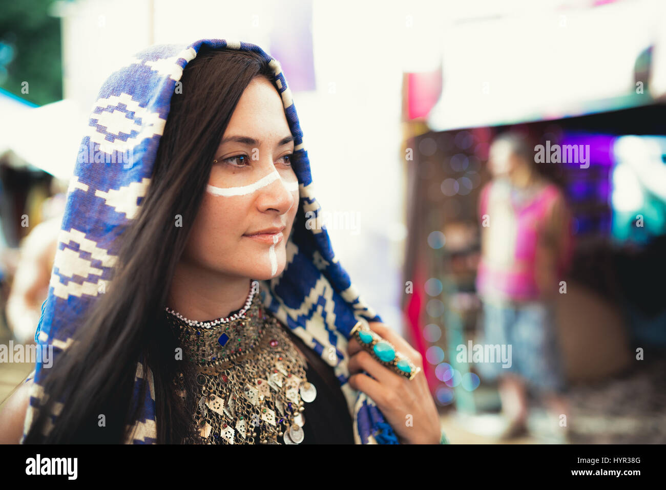 Female music festival attendee in costume and face paint. Stock Photo