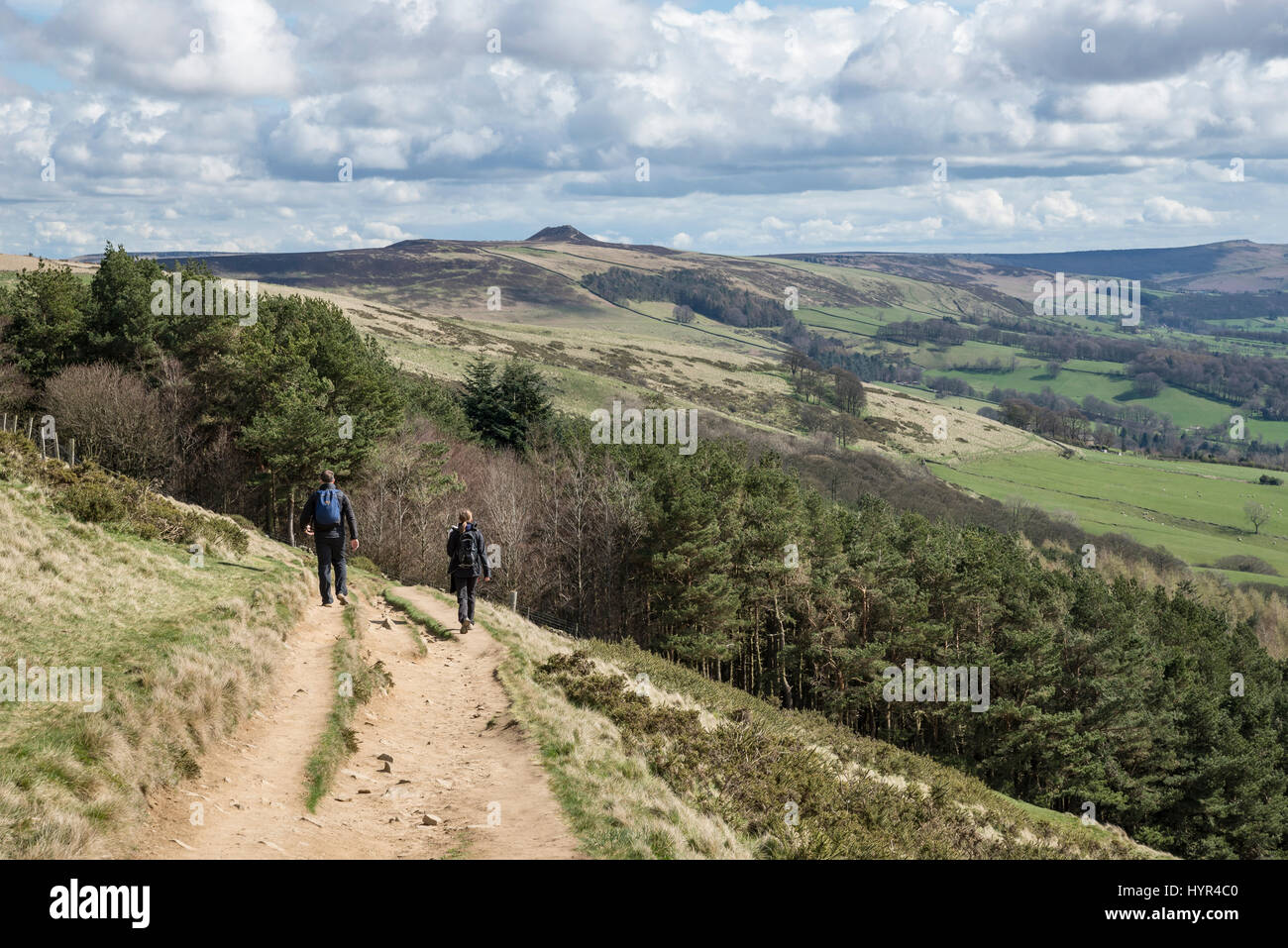 Couple walking on the great ridge from Mam Tor to Lose Hill on a sunny spring day in the Peak District national park, England. Stock Photo