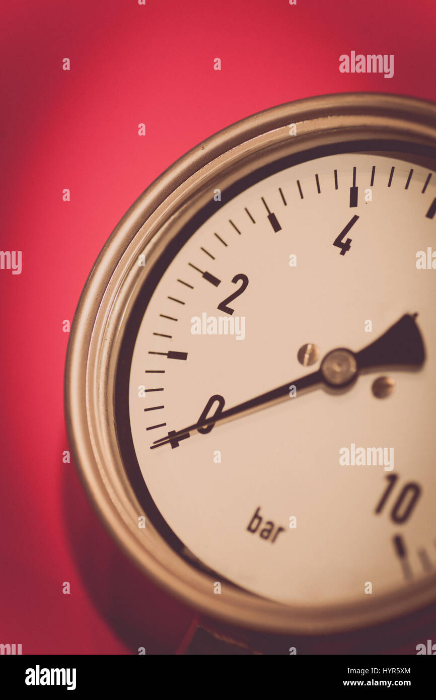 Close up shot of a pressure gauge on a red background Stock Photo - Alamy