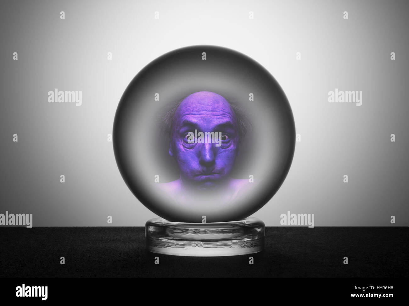 Crystal ball with tense frightened face Stock Photo