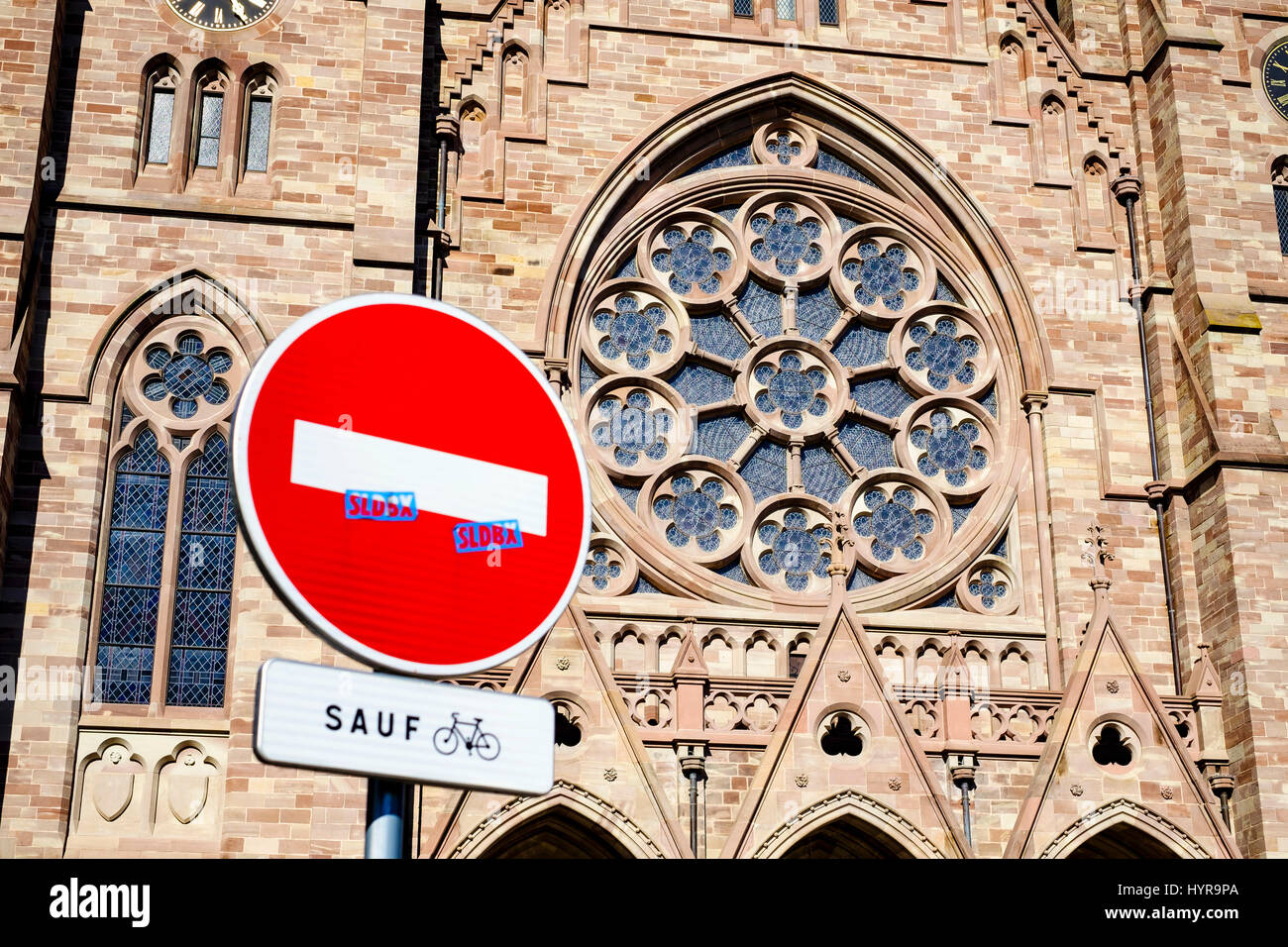 No entry sign except for cyclists and St Paul protestant church's rose window, Strasbourg, Alsace, France Stock Photo