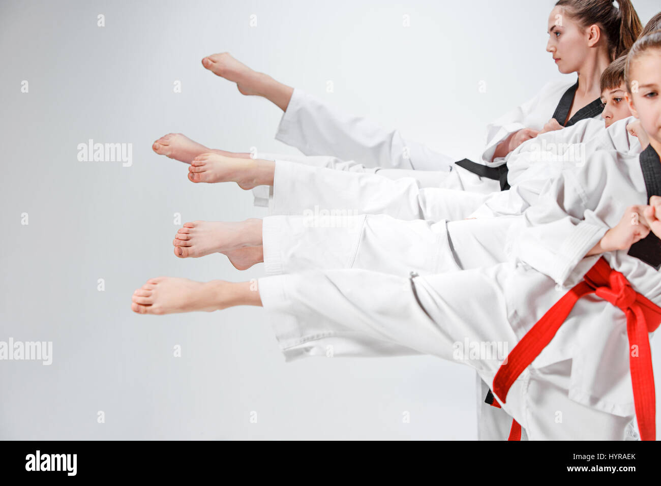 The studio shot of legs of group of kids training karate martial arts