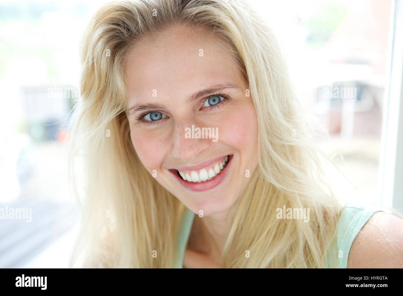 Close up portrait of a happy smiling young blond woman Stock Photo - Alamy