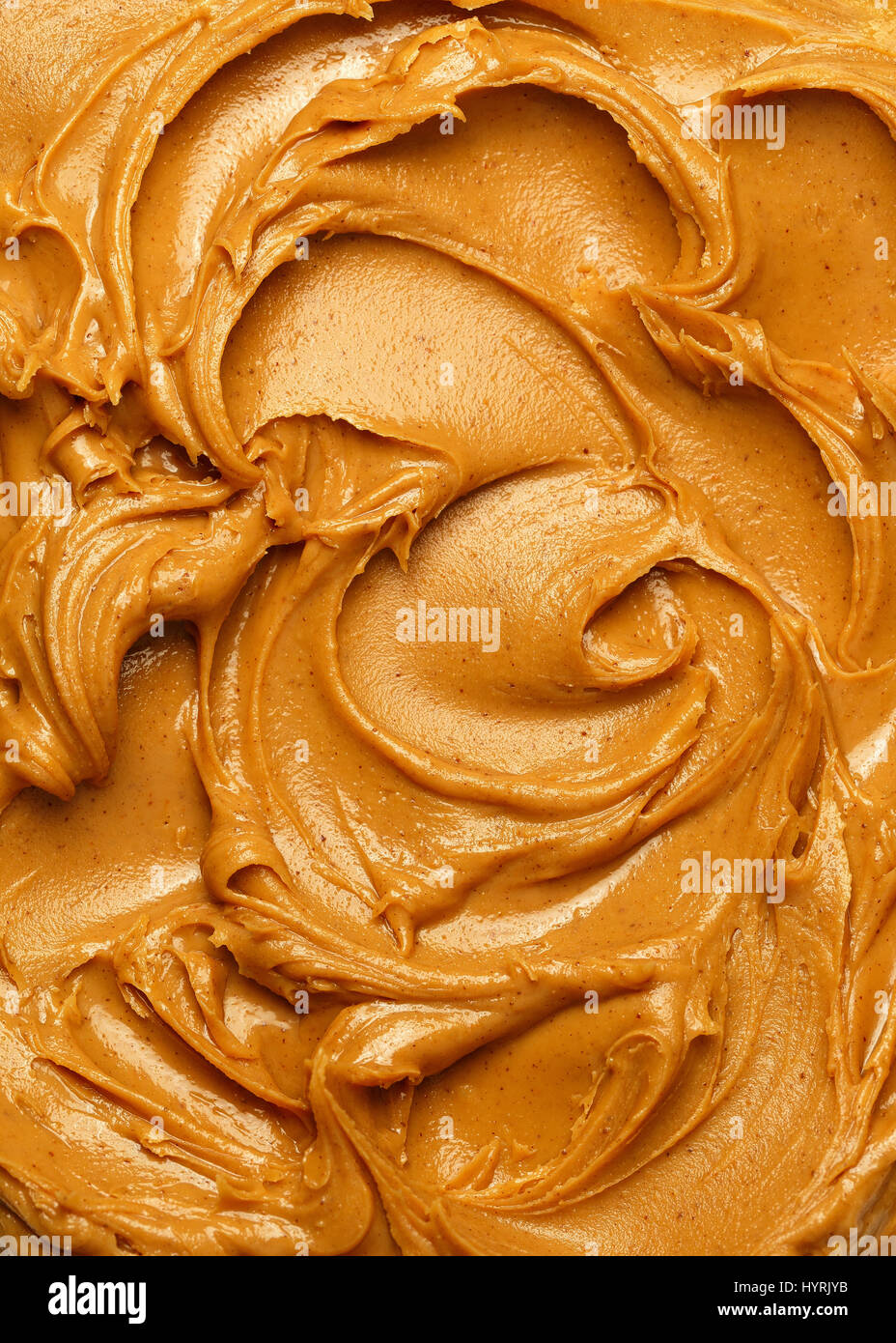 Swirls of creamy peanut butter spread. Stock Photo